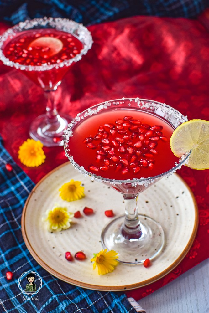 Pomegranate Martini recipe served with pomegranate seeds in a cocktail glass