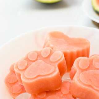 A bowl of watermelon yogurt popsicle which are homemade frozen treats for dogs.